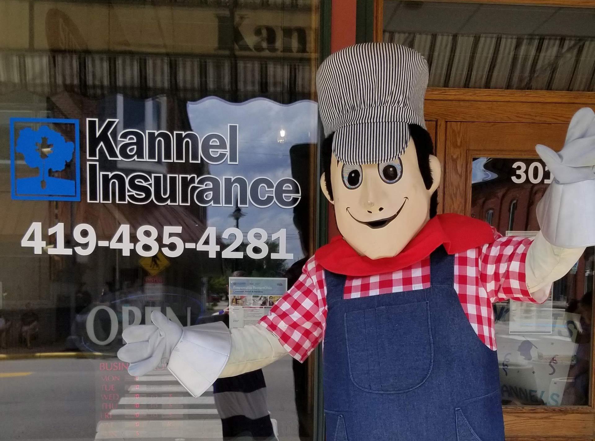 kannel insurance mascot in front of window sign montpelier oh